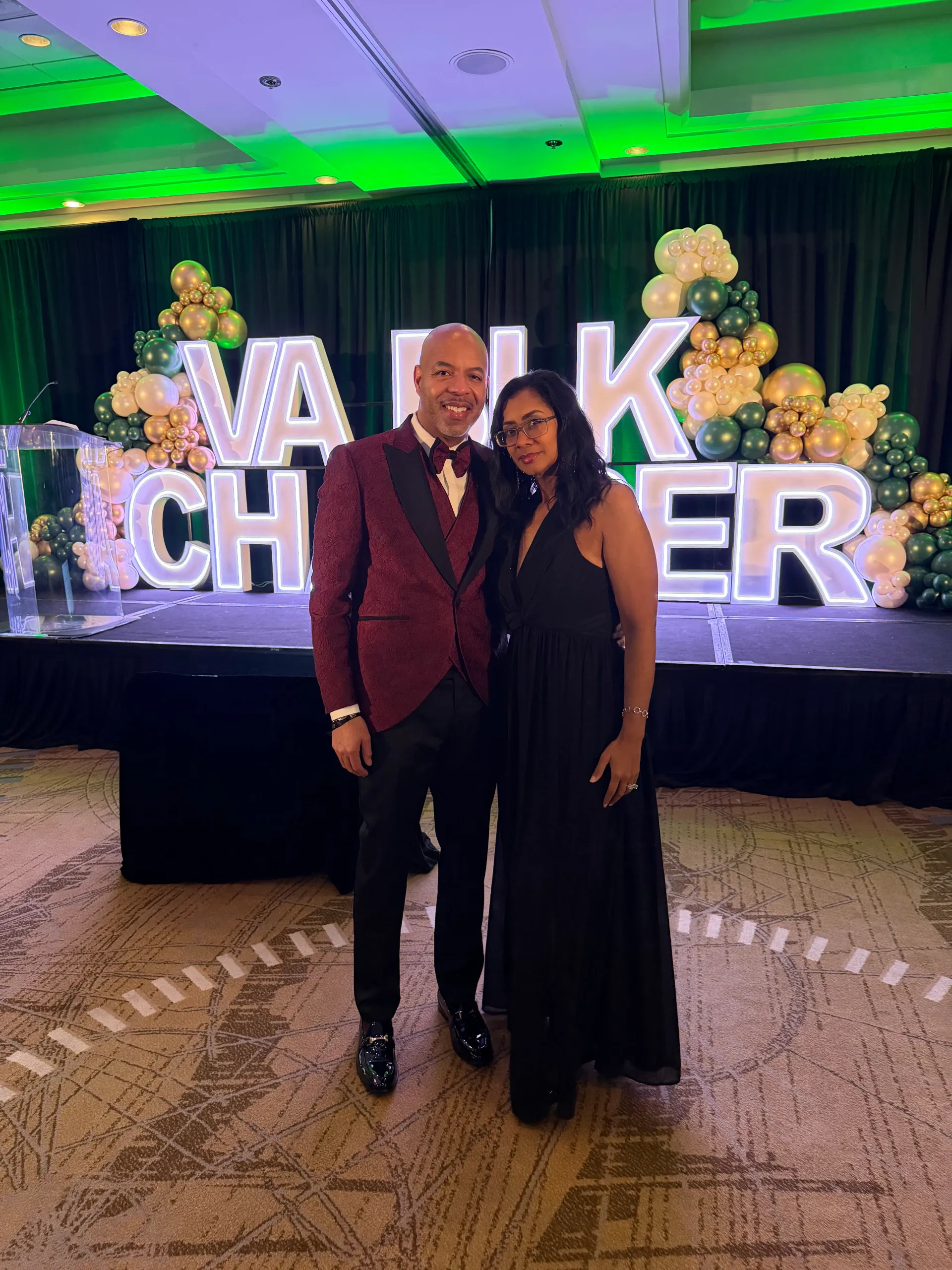 KC and Nat standing together beneath gala marquee letters