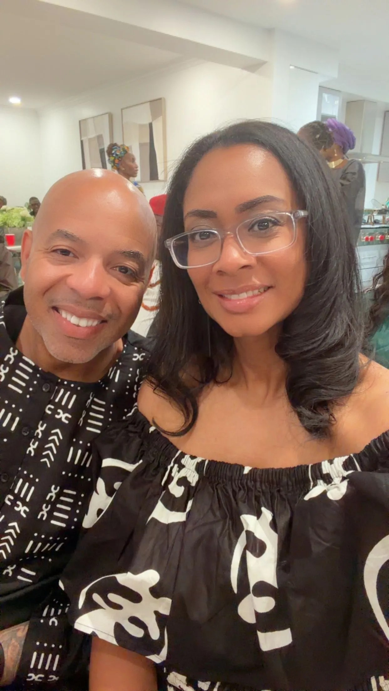 KC and Nat smiling together at a community celebration